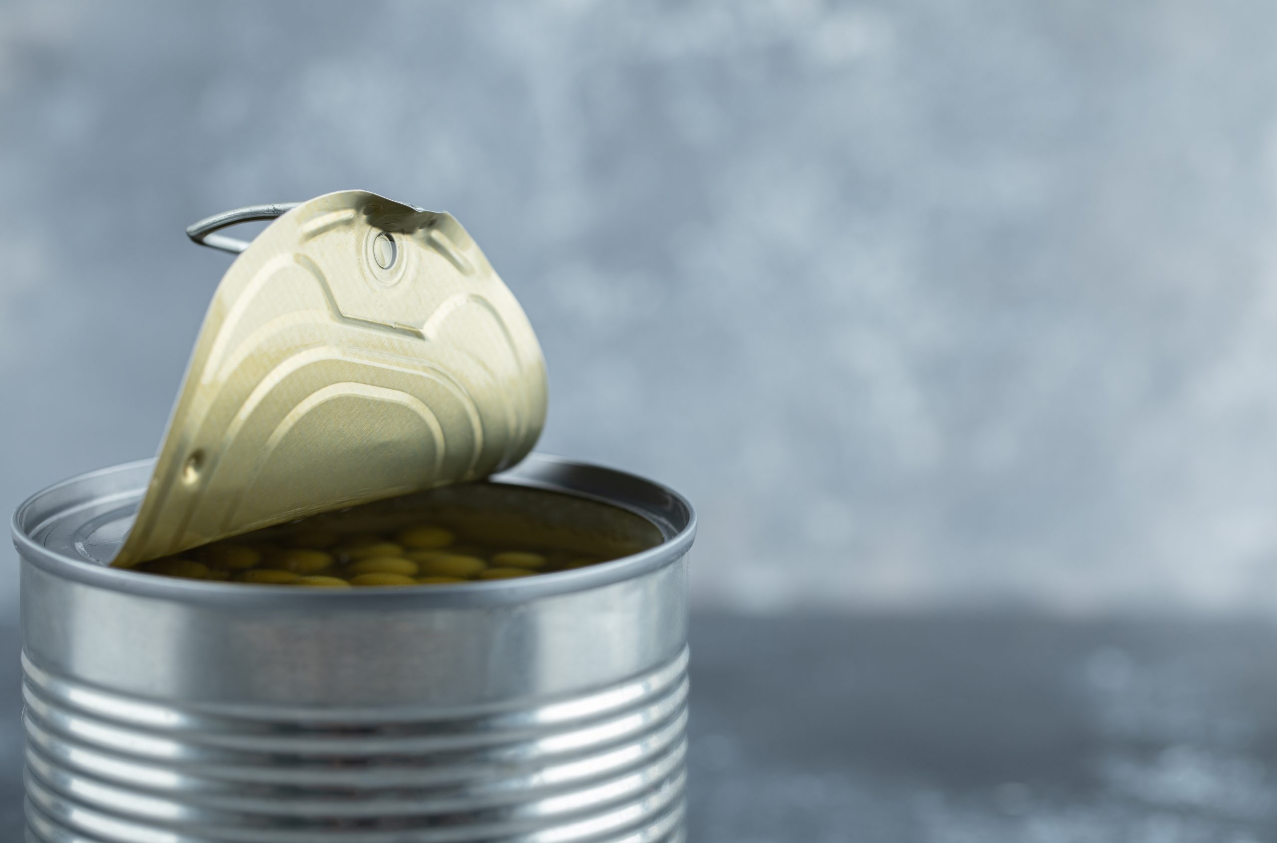 Opened tin of green peas